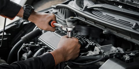 Mechanic fixing a car at home